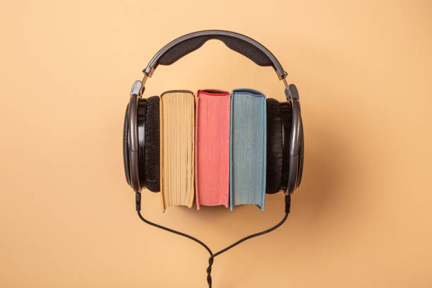 headphones on books, audiobooks concept audiolibros free
